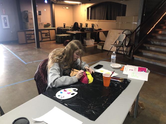  Haley Lehman/ News-miner Chelsea Curwen Paints a mask yellow and purple as part of art therapy
